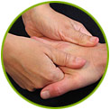 Two hands giving a massage to another hand, with fingers pressing into the palm.